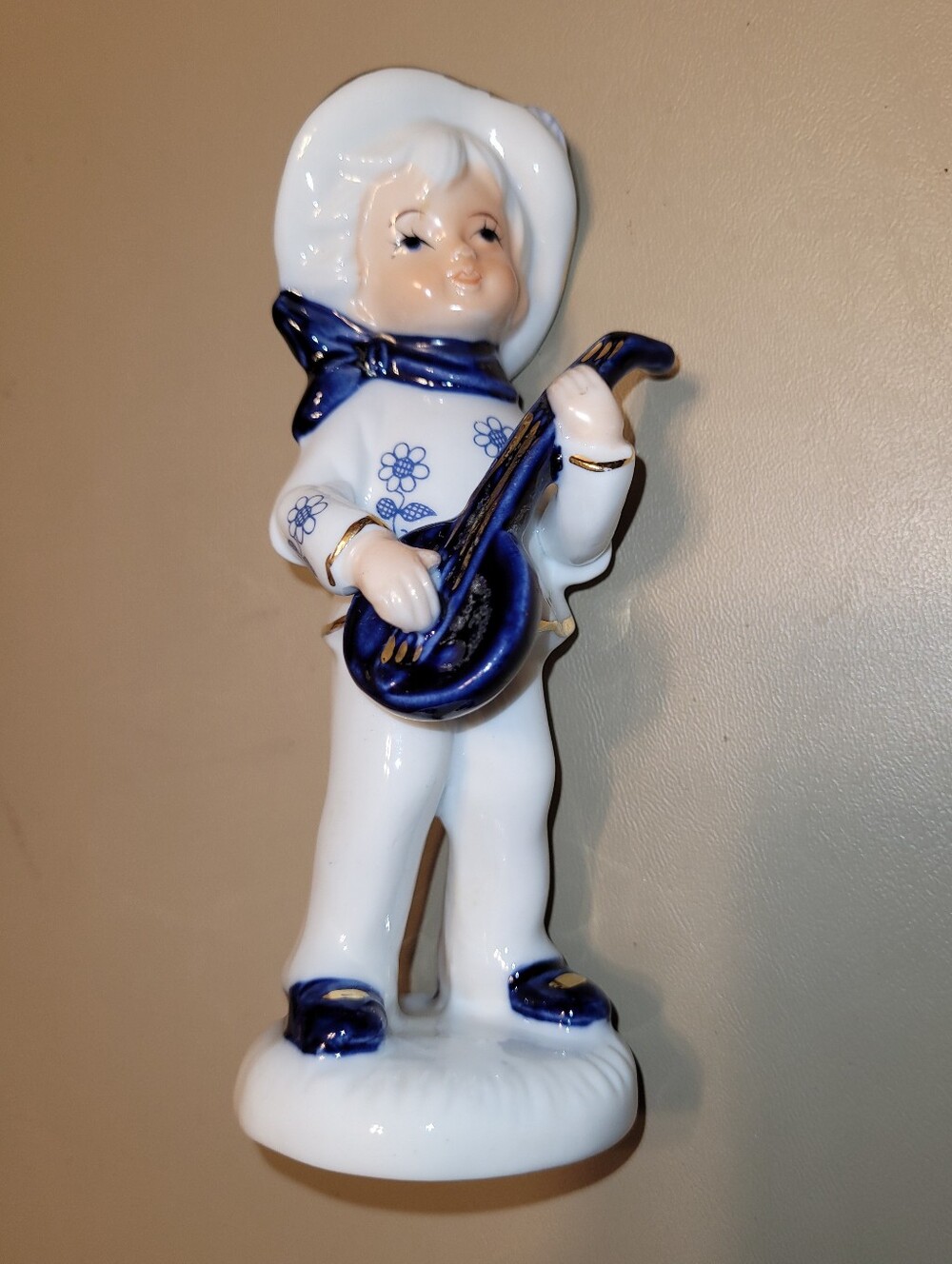 Enesco White and Blue Porcelain Musician Figurine with Gold Trim.